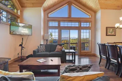 a living room with a couch and a table at Hilltop Hideaway w Game Room & Forest Views in Truckee