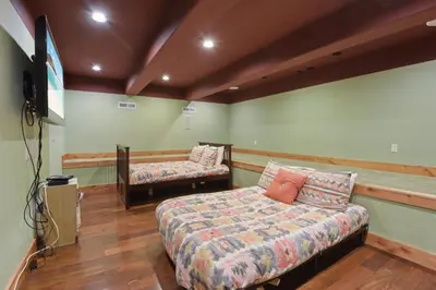 a bedroom with a bed and a tv in it at Hilltop Hideaway w Game Room & Forest Views in Truckee