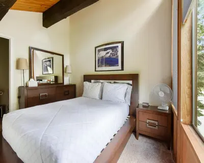 a bedroom with a white bed and a window at Enjoy Forest Views Retreat at Kingswood Village in Kings Beach