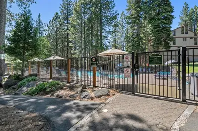 a metal fence with a pool in a park at Enjoy Forest Views Retreat at Kingswood Village in Kings Beach