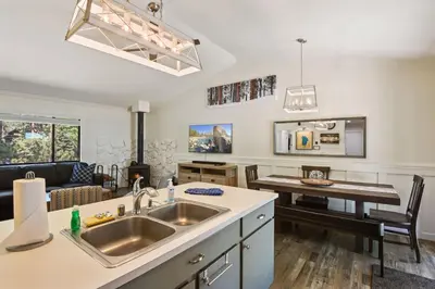 a kitchen with a sink and a living room at Incline Bliss Dreamy Pet Friendly Escape in Incline Village