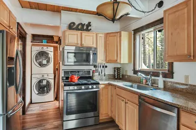 a kitchen with stainless steel appliances and wooden cabinets at Incline Cottage Year-Round Outdoor Fun in Incline Village