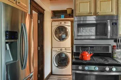 a kitchen with a stove and washing machines and a tea kettle at Incline Cottage Year-Round Outdoor Fun in Incline Village