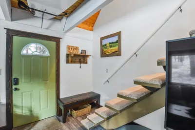 a green door in a room with stairs at Incline Cottage Year-Round Outdoor Fun in Incline Village