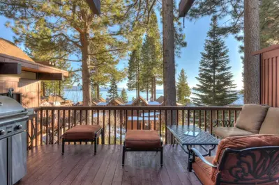 a deck with a grill and a table and chairs at Crystal Shores Villa Lake Views & Hiking in Incline Village