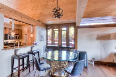 a kitchen with a glass table and some chairs at Crystal Shores Villa Lake Views & Hiking in Incline Village