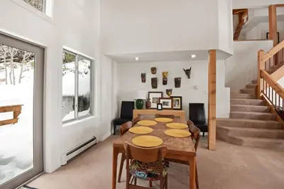 a dining room with a table and chairs and stairs at Incline Village Manor Near Beach & More in Incline Village