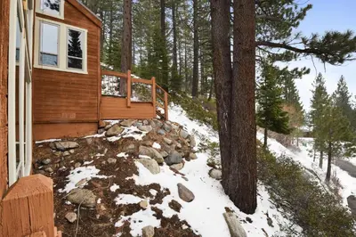a cabin with snow on the ground next to a tree at Incline Village Manor Near Beach & More in Incline Village