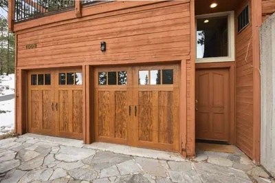 a pair of wooden garage doors on a house at Incline Village Manor Near Beach & More in Incline Village