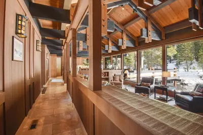 a large room with wooden ceilings and windows at Joy on the River Stunning Waterfront Home for 10 in Olympic Valley