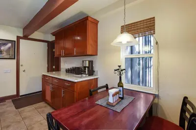 a kitchen with a wooden table with a bottle of wine at Tahoe City Getaway Minutes from Lake and Activities in Tahoe City