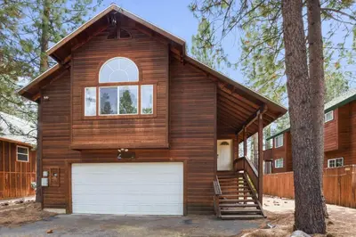 a house with a garage and a tree at Kings Beach Bliss Walk to Outdoor Fun in Kings Beach