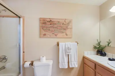 a bathroom with a toilet and a map on the wall at Kings Beach Bliss Walk to Outdoor Fun in Kings Beach