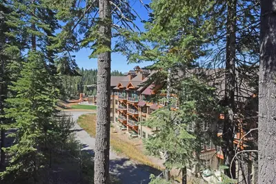 an aerial view of the lodge through the trees at A Golden Getaway Pool Hot Tub Tennis & More in Truckee