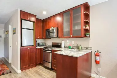 a kitchen with wooden cabinets and a stove top oven at Kings Run Retreat Patio in Tahoe Vista