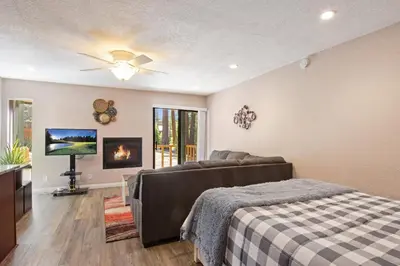 a bedroom with a bed and a flat screen tv at Kings Run Retreat Patio in Tahoe Vista