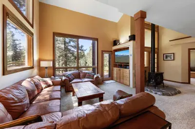 a living room with a leather couch and a table at Kitzbuhel Paradise Sleeps 8 in Truckee
