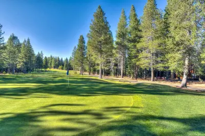 a golf course with trees and a putting green at Kitzbuhel Paradise Sleeps 8 in Truckee
