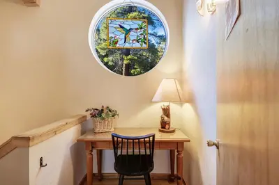 a small table with a chair and a window at Lakeview Hideaway 3BDR for 8 w Private Hot Tub in Carnelian Bay