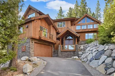 a large wooden house with a driveway at Luxury Mountain Chalet Deck w BBQ & Lake Views in Tahoe City