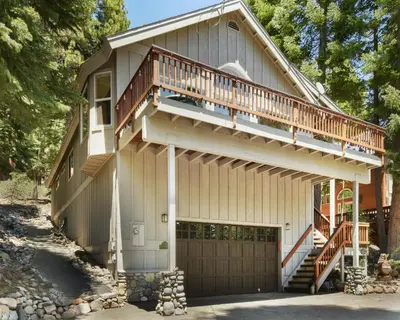 a house with a deck and a garage at Lux Leisure Game Room & More in Truckee