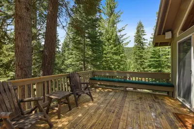 a deck with two chairs and a bench on it at Luxury Tahoe Chalet Minutes to Dining in Tahoe Vista