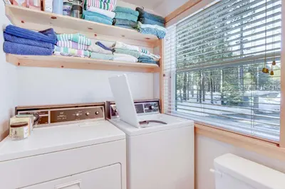 a laundry room with a washing machine and a window at McKinney Estate w Roof Deck Beach & Hike in Tahoma