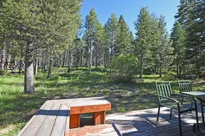 a picnic table and a bench on a wooden deck at McKinney Estate w Roof Deck Beach & Hike in Tahoma