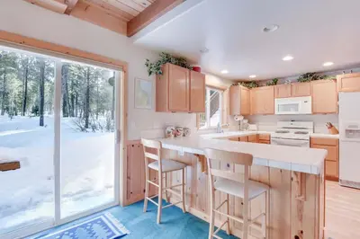 a kitchen with a counter and a large window at McKinney Estate w Roof Deck Beach & Hike in Tahoma