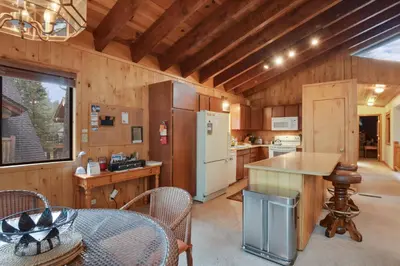 a kitchen with a refrigerator and a table and chairs at Lake Tahoe Treasure Minutes from Beach & Skiing in Tahoma