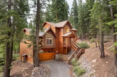 a log cabin in the woods with a staircase at Modern Lake Tahoe Retreat Ski and Swim in Tahoe Vista