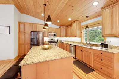a kitchen with wooden cabinets and a large island at Modern Lake Tahoe Retreat Ski and Swim in Tahoe Vista