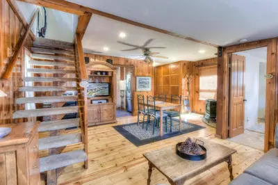 a log home with a spiral staircase in a living room at Moonlight Cove w Grill Tahoe Beach Next Door in Tahoe Vista
