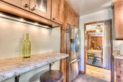a kitchen with a bottle of wine on a counter at Moonlight Cove w Grill Tahoe Beach Next Door in Tahoe Vista
