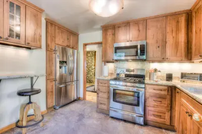 a kitchen with wooden cabinets and stainless steel appliances at Moonlight Cove w Grill Tahoe Beach Next Door in Tahoe Vista