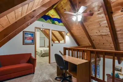 a living room with a ceiling fan and a desk at Moose Cabin Year Round Outdoor Fun w BBQ in Carnelian Bay