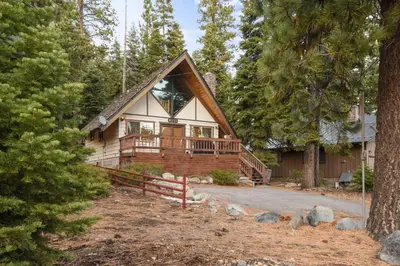 a cabin in the woods with a wrap around porch at Moose Cabin Year Round Outdoor Fun w BBQ in Carnelian Bay
