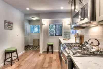 a kitchen with a stove and two stools at Moose Manor w BBQ Near Tahoe Hiking in Tahoma
