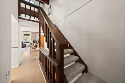 a staircase in a home with a wooden railing at Mountain Shadows Chalet Tahoe Fun Awaits in Incline Village