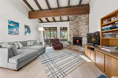 a living room with a couch and a fireplace at Mountain Shadows Chalet Tahoe Fun Awaits in Incline Village
