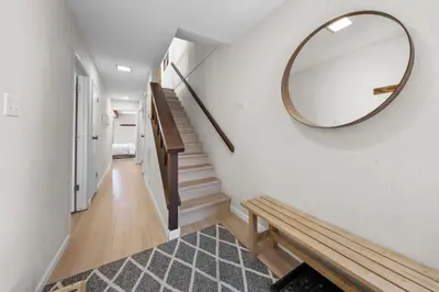 a hallway with a large mirror and a wooden bench at Mountain Shadows Chalet Tahoe Fun Awaits in Incline Village