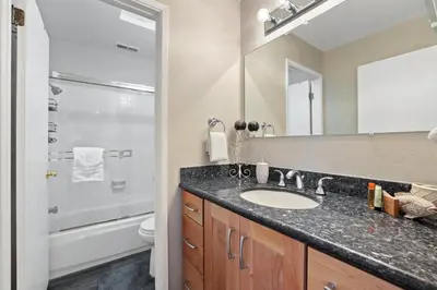 a bathroom with a sink and a toilet and a mirror at Family Fun Getaway - 3 Story Condo in Zephyr Cove
