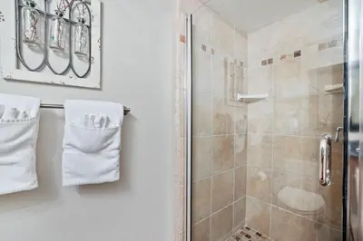 a bathroom with a shower stall and white towels at Family Fun Getaway - 3 Story Condo in Zephyr Cove