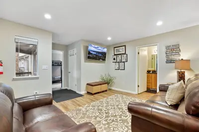 a living room with a couch and a television at Family Fun Getaway - 3 Story Condo in Zephyr Cove