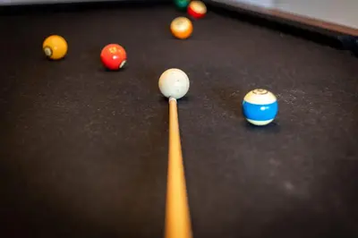 a cue ball and balls on a pool table at Hall Court Manor - Hot tub Pet Friendly Pool Table in Stateline