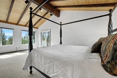 a bedroom with a canopy bed in a room with windows at Hall Court Manor - Hot tub Pet Friendly Pool Table in Stateline