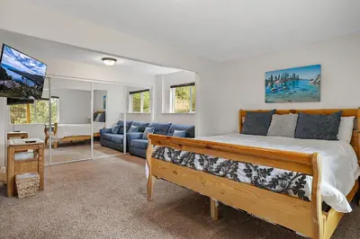 a bedroom with a bed and a living room at Hall Court Manor - Hot tub Pet Friendly Pool Table in Stateline
