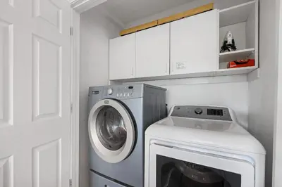 a washer and dryer in a white laundry room at Hall Court Manor - Hot tub Pet Friendly Pool Table in Stateline
