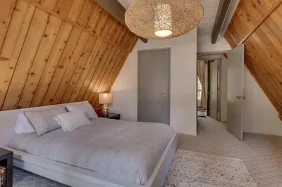 a bedroom with a large bed with a wooden ceiling at Heavenly Hollow in South Lake Tahoe