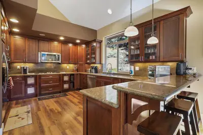 a kitchen with wooden cabinets and a large island at Heavenly Mountain Chalet - Skiing Pets Hot tub in Stateline